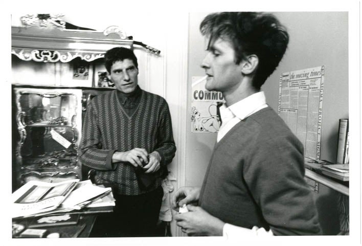Item #39343 An original b/w photograph by John Hopkins of Alexander Trocchi with Ian Sommerville in Trocchi's flat in St. Stephen's Gardens, Notting Hill, c. late 1964.