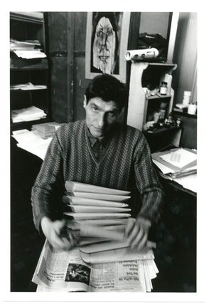 Item #39344 An original b/w photograph by John Hopkins of Alexander Trocchi sitting at his desk...