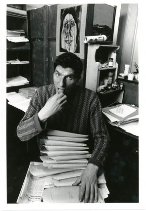 Item #39345 An original b/w photograph by John Hopkins of Alexander Trocchi sitting at his desk...