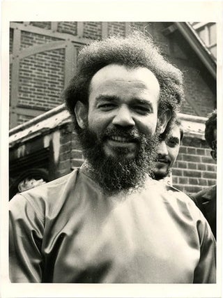 Item #39738 PRESS PHOTOGRAPH. An original b/w press photograph of Michael X, taken outside...