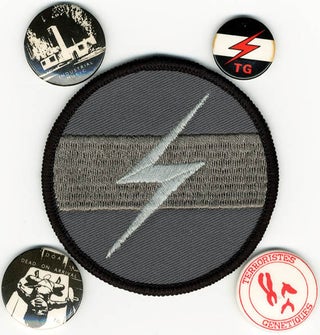 Item #40753 A group of four original TG badges and an original TG flash patch. THROBBING GRISTLE
