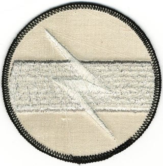 A group of four original TG badges and an original TG flash patch.