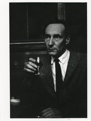 Item #41006 A b/w photograph of William Burroughs in the bar of the Beat Hotel, Paris, 1961....