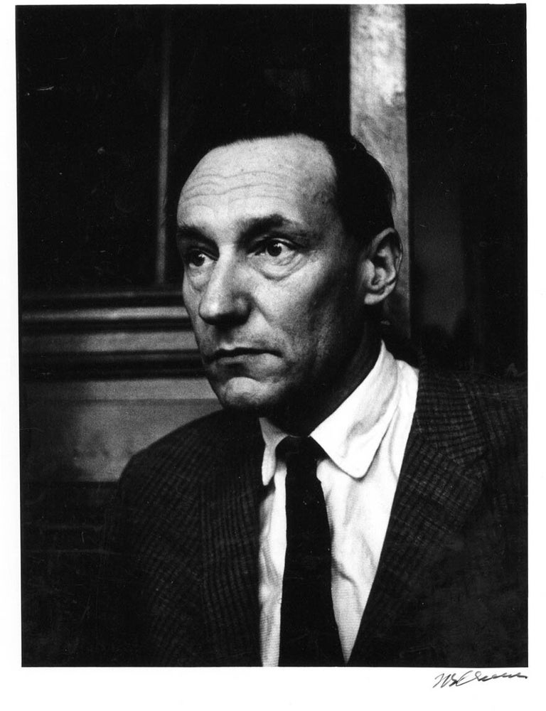 Item #41186 A b/w photograph of William Burroughs in the bar of the Beat Hotel, Paris, 1961. William S. BURROUGHS, Harold CHAPMAN.