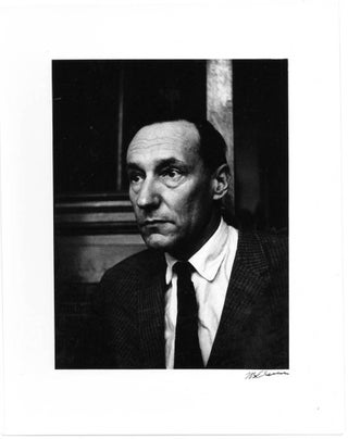 A b/w photograph of William Burroughs in the bar of the Beat Hotel, Paris, 1961.