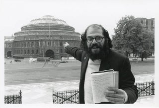 Item #41219 A b/w photograph by John ‘Hoppy’ Hopkins of Allen Ginsberg, journal in hand,...
