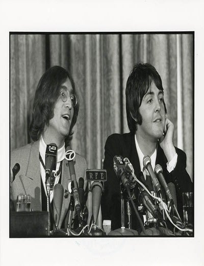 An original 8x10 photograph by Linda McCartney of John Lennon and Paul McCartney at a press. The BEATLES.