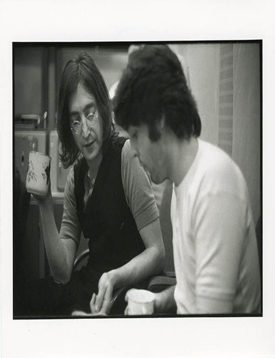 An 8x10 b/w photograph by Linda McCartney of John Lennon and Paul McCartney during the mixing. John LENNON, Paul McCARTNEY.